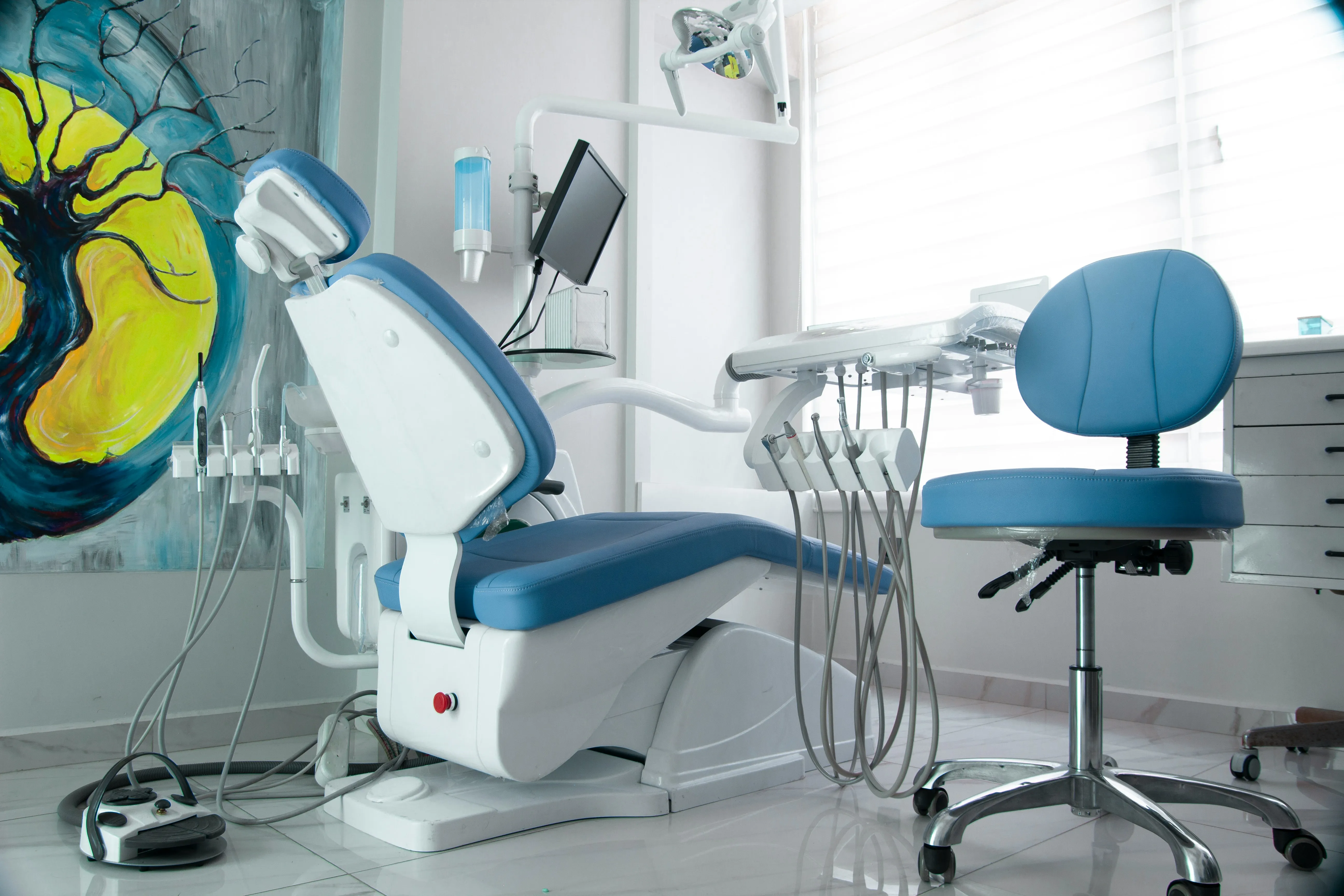 A dental operatory with chair, monitor and instrument unit