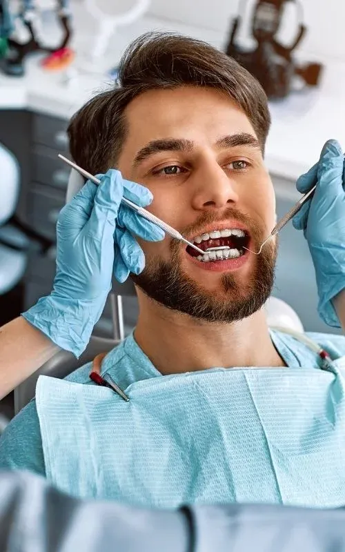 An adult patient having their upper teeth examined